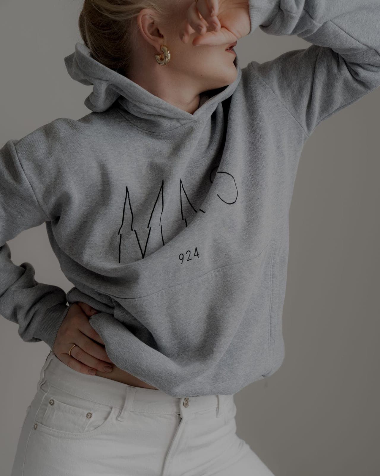 Back detail of a grey training hoodie