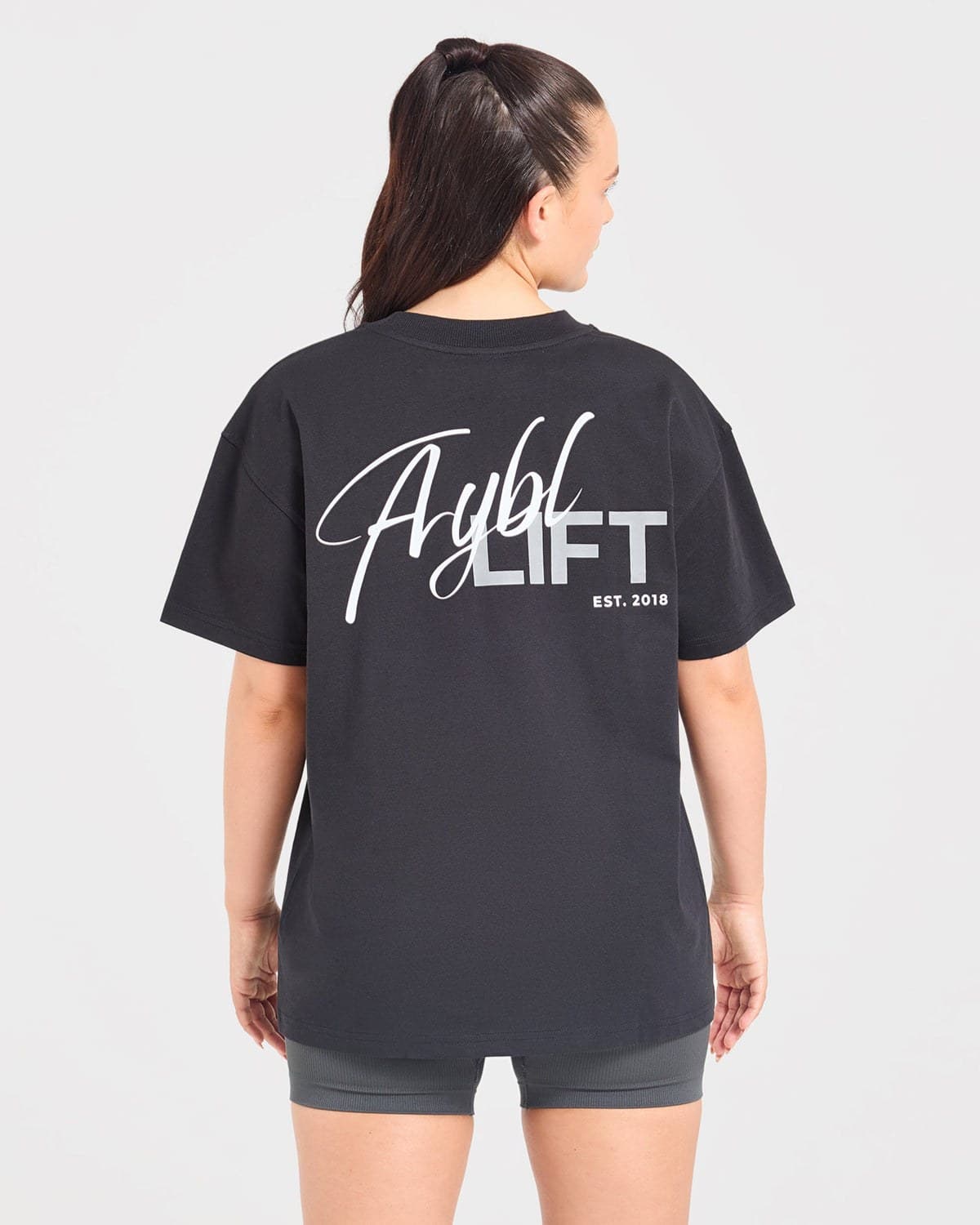 Black oversized lift-graphic training tee on model