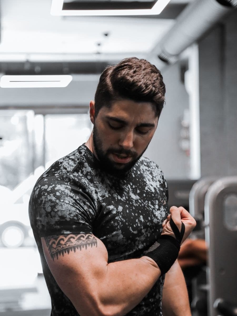 A man in a performance training tee in the gym