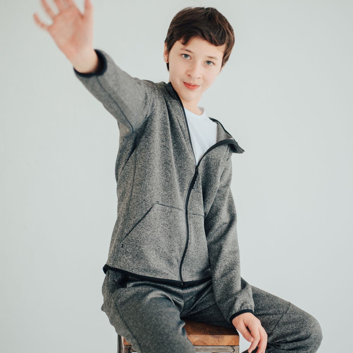 Model in a charcoal marl zip training jacket