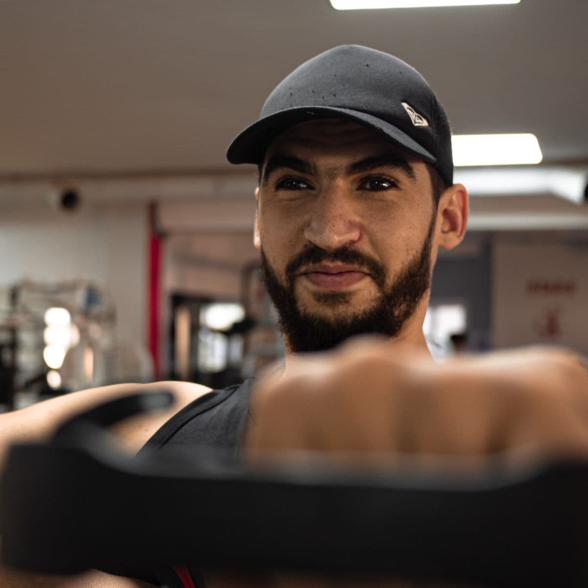 An athlete wearing a black sports cap