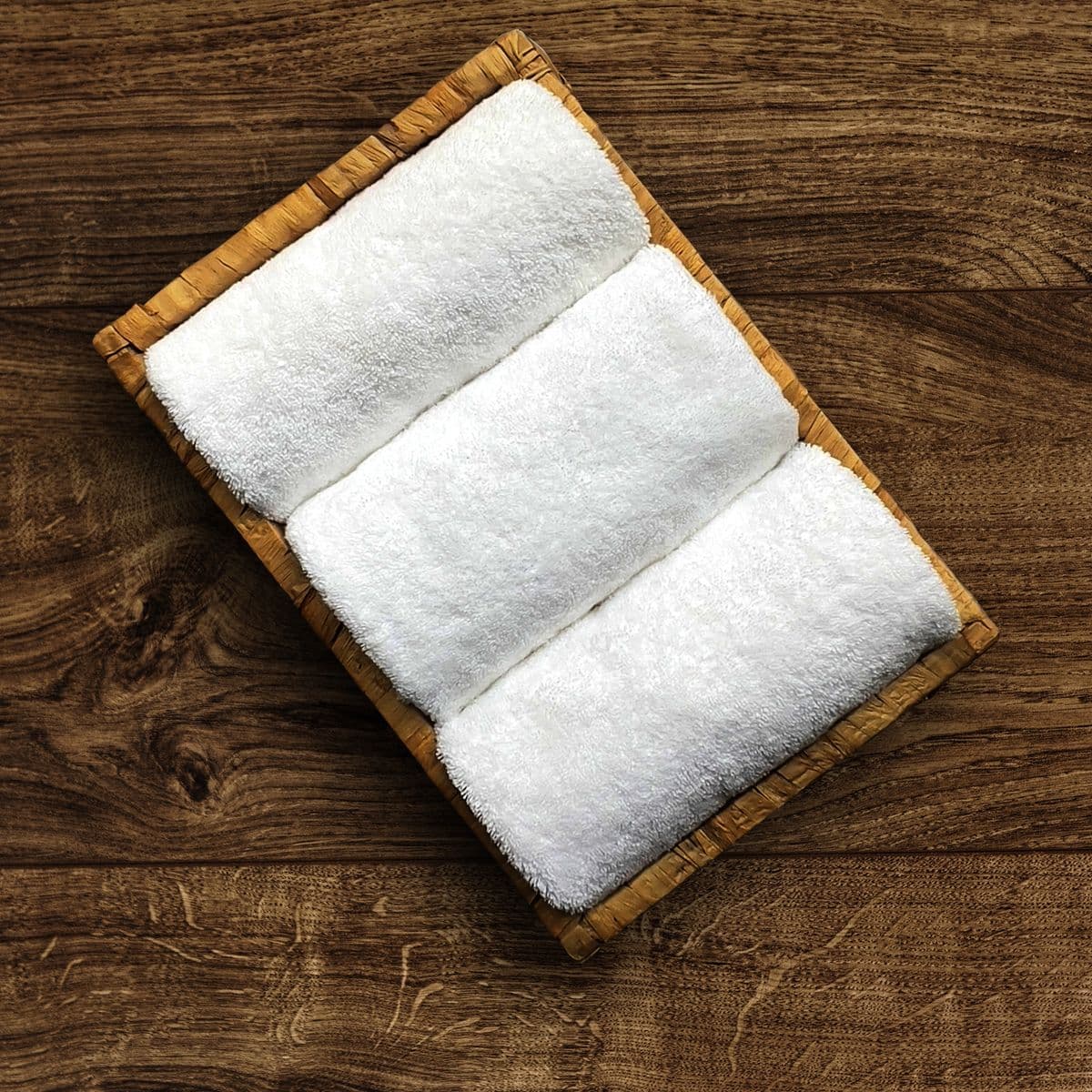 Rolled white gym towels on a tray