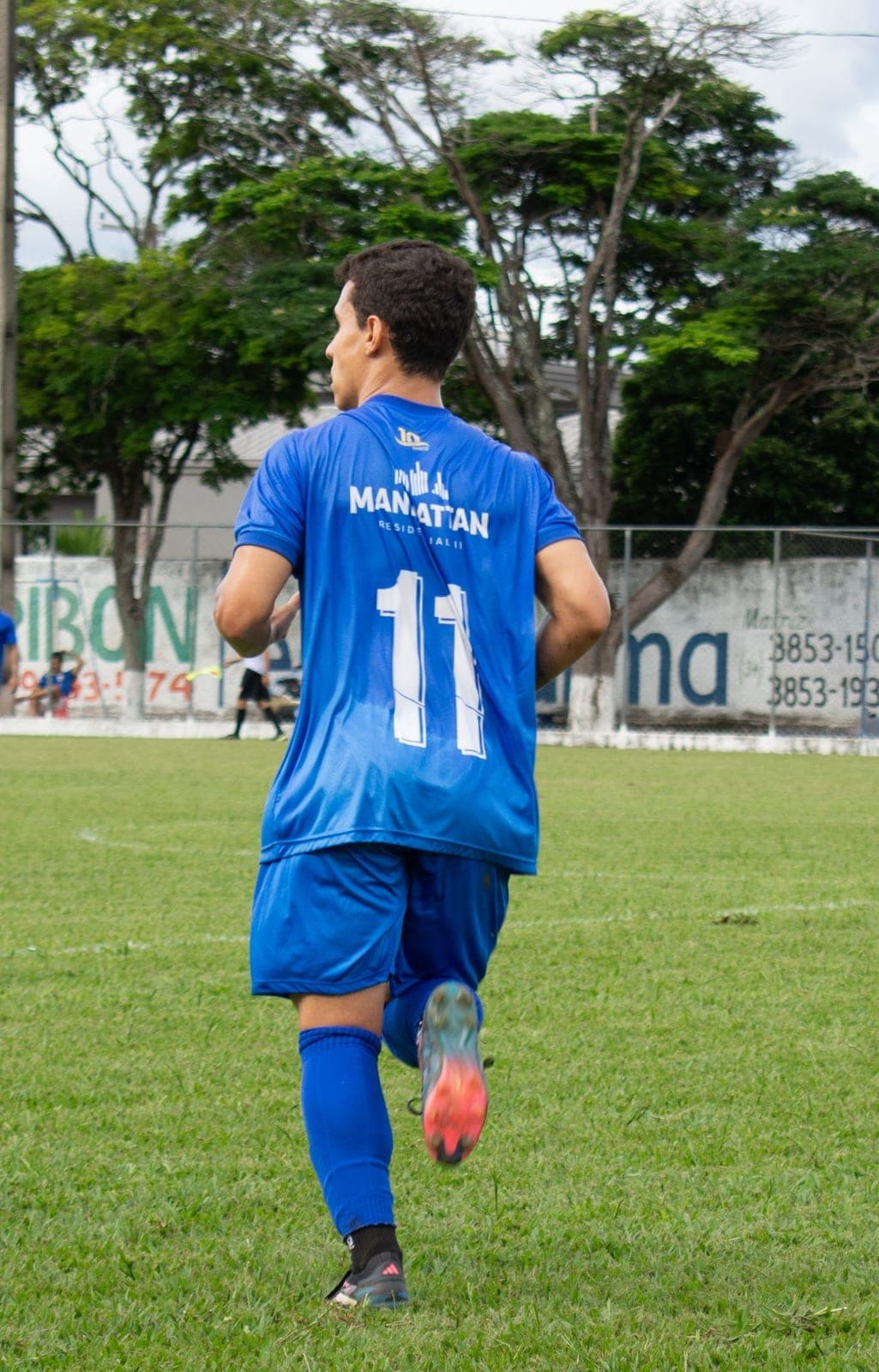 A player in a blue team jersey