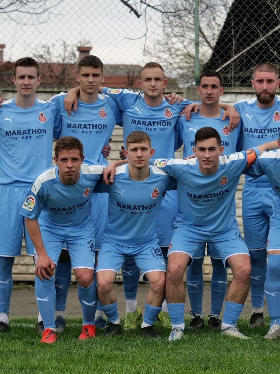 A football team in matching sky-blue kit