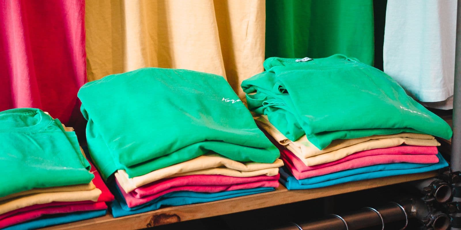 Folded stacks of team shirts on a bench