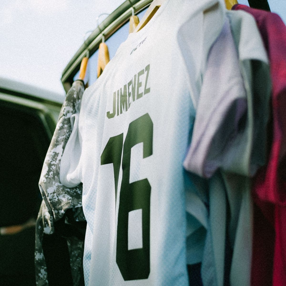 A white sublimated jersey hung on a rail