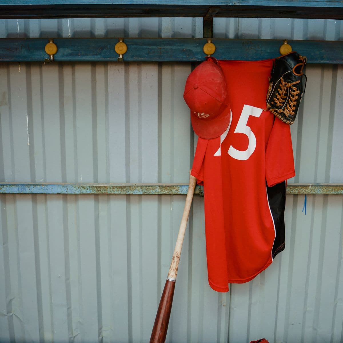A red number kit with cap and glove hung up