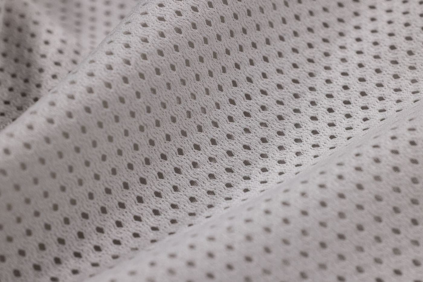 Close detail of grey performance mesh fabric