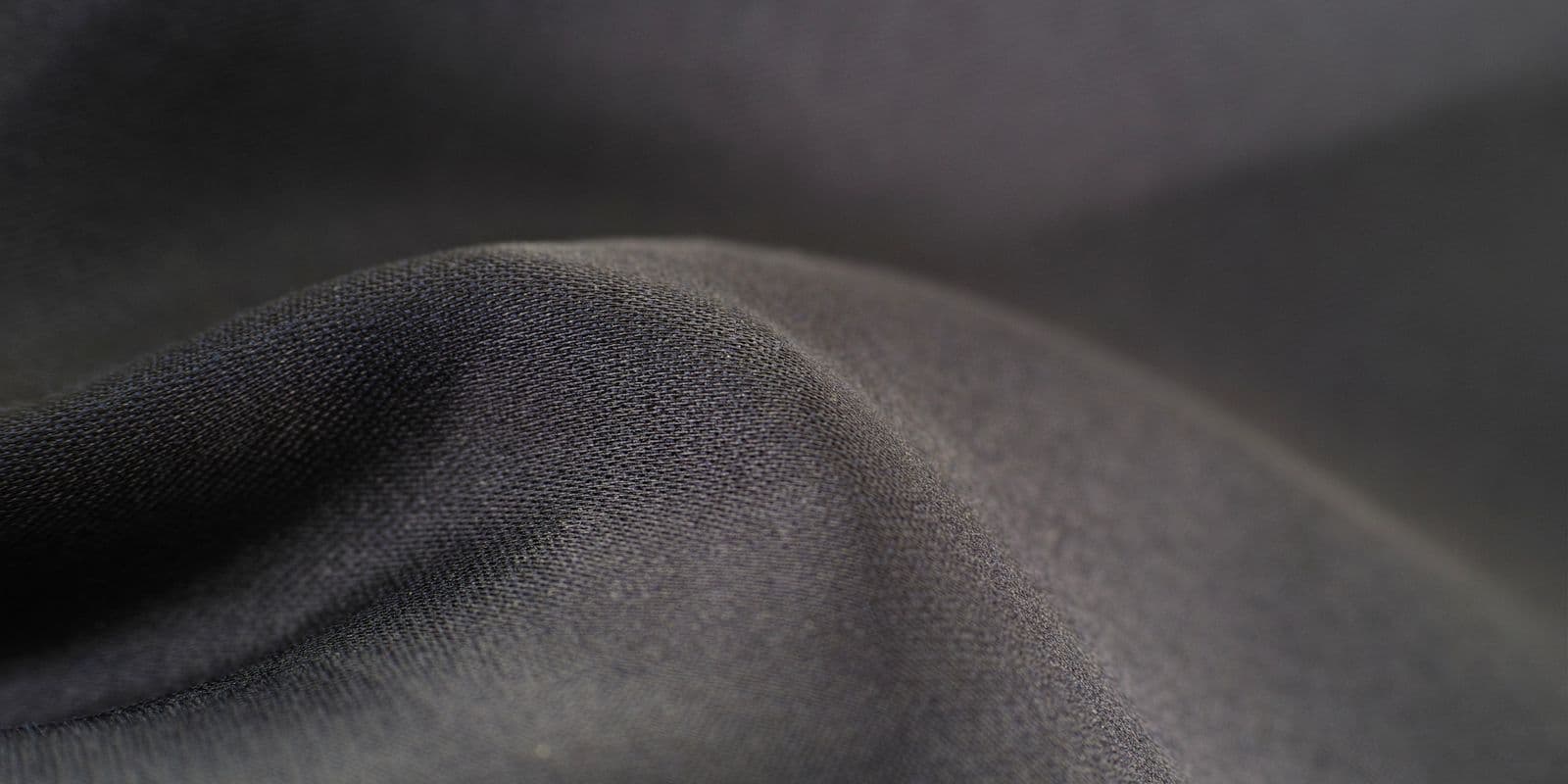 Smooth charcoal-grey performance jersey in soft waves