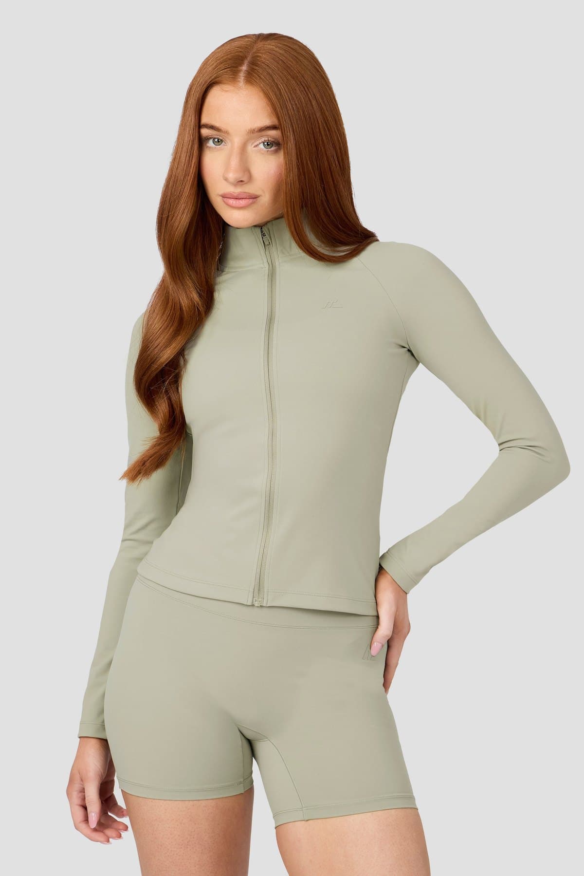 Female model in a sage seamless zip jacket set