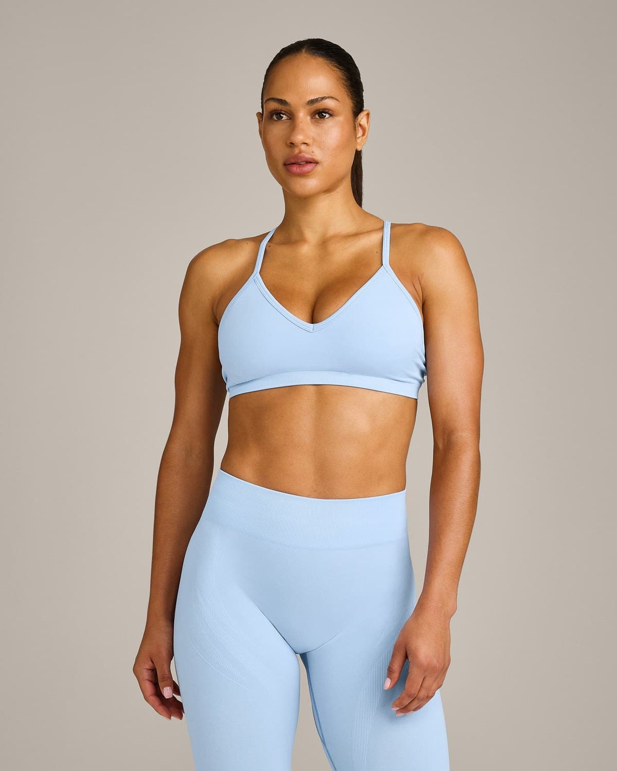 Female model in a sky blue seamless bra and leggings