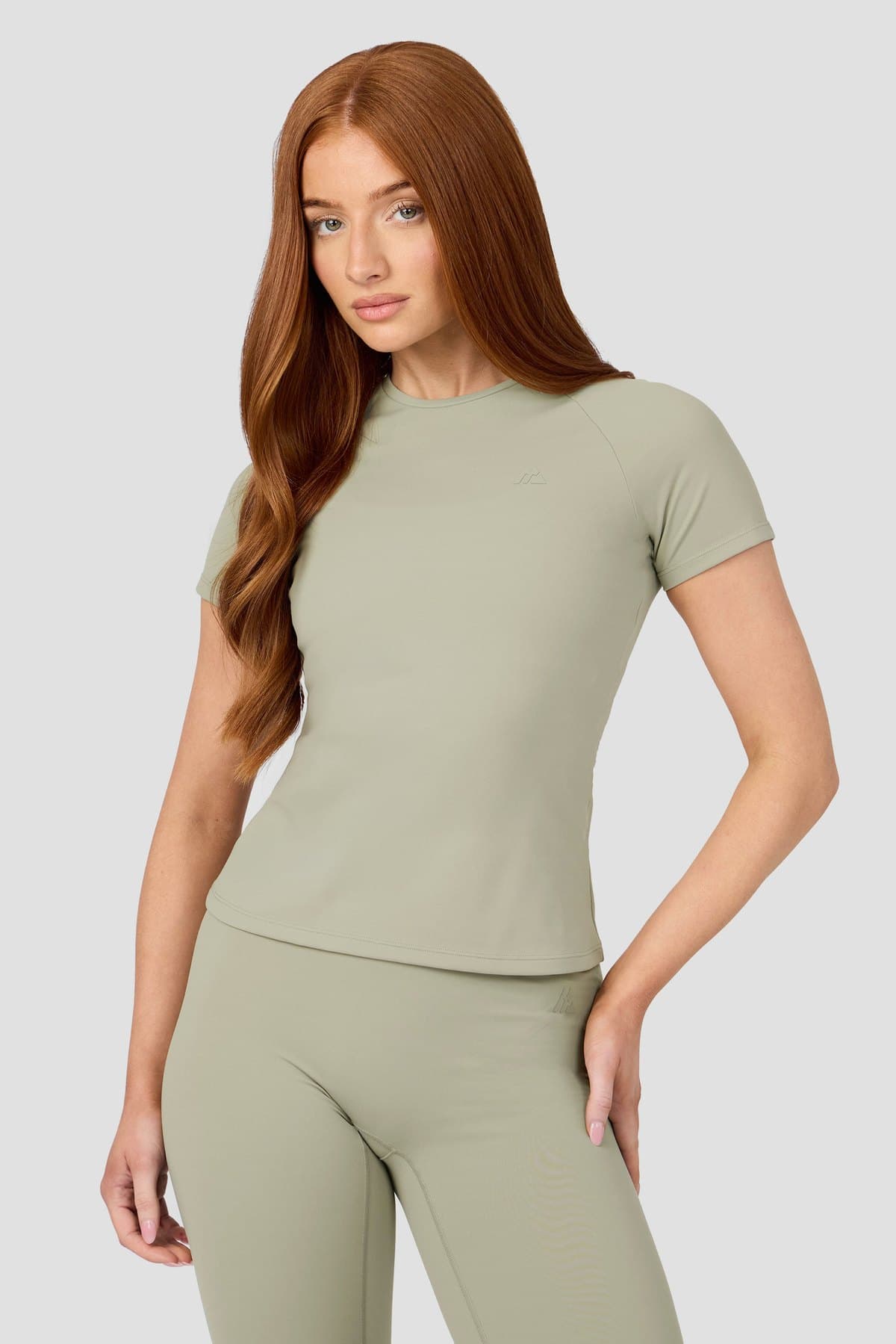 Female model in a sage seamless tee and leggings