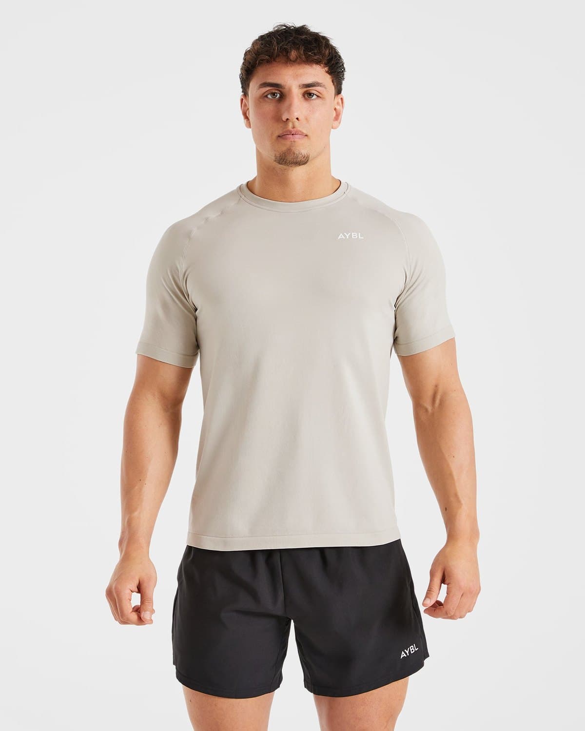 Male model in a stone seamless performance t-shirt