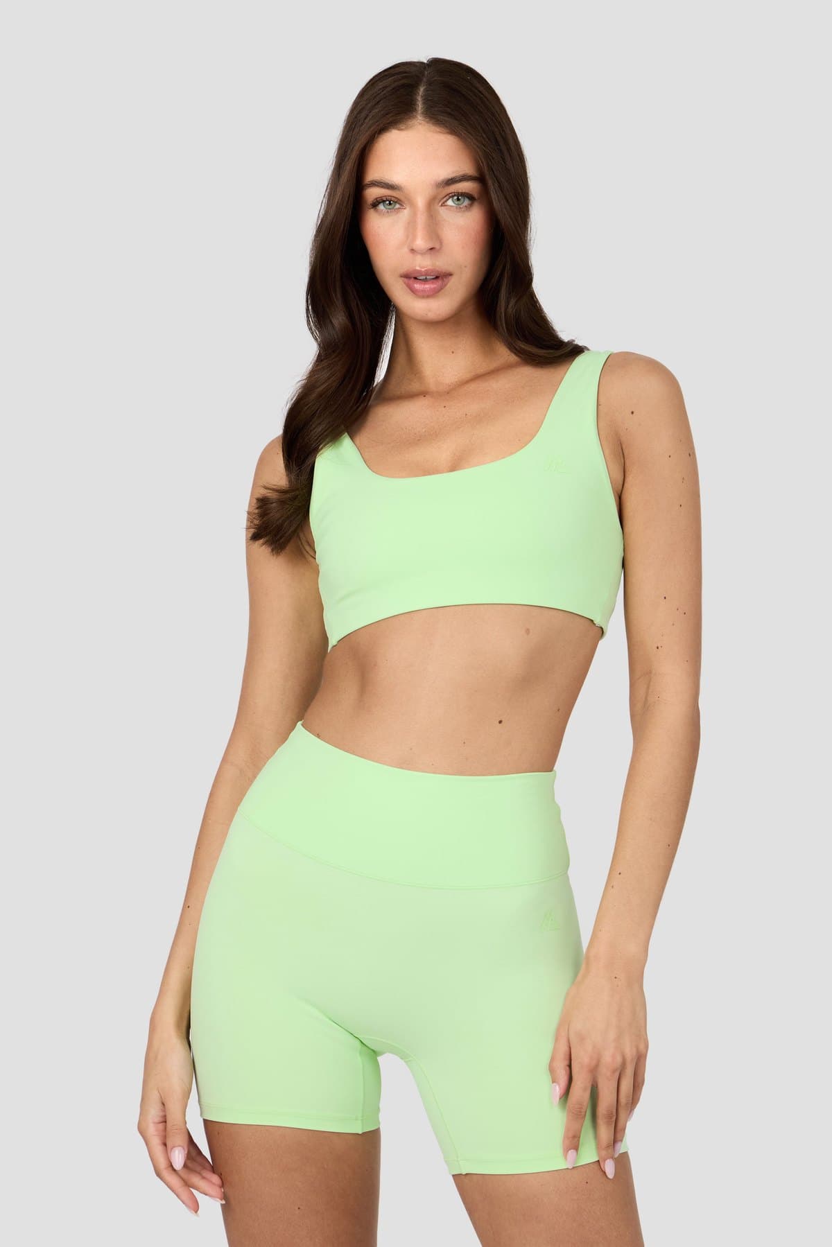 Female model in a lime seamless bra and shorts