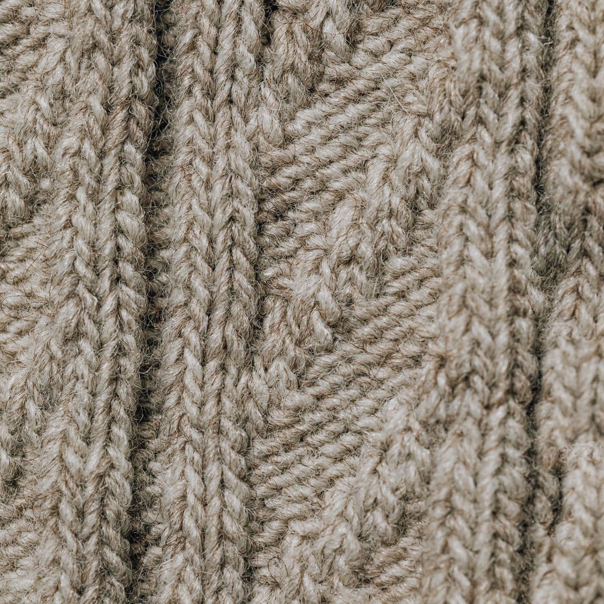 Beige cable-knit wool texture