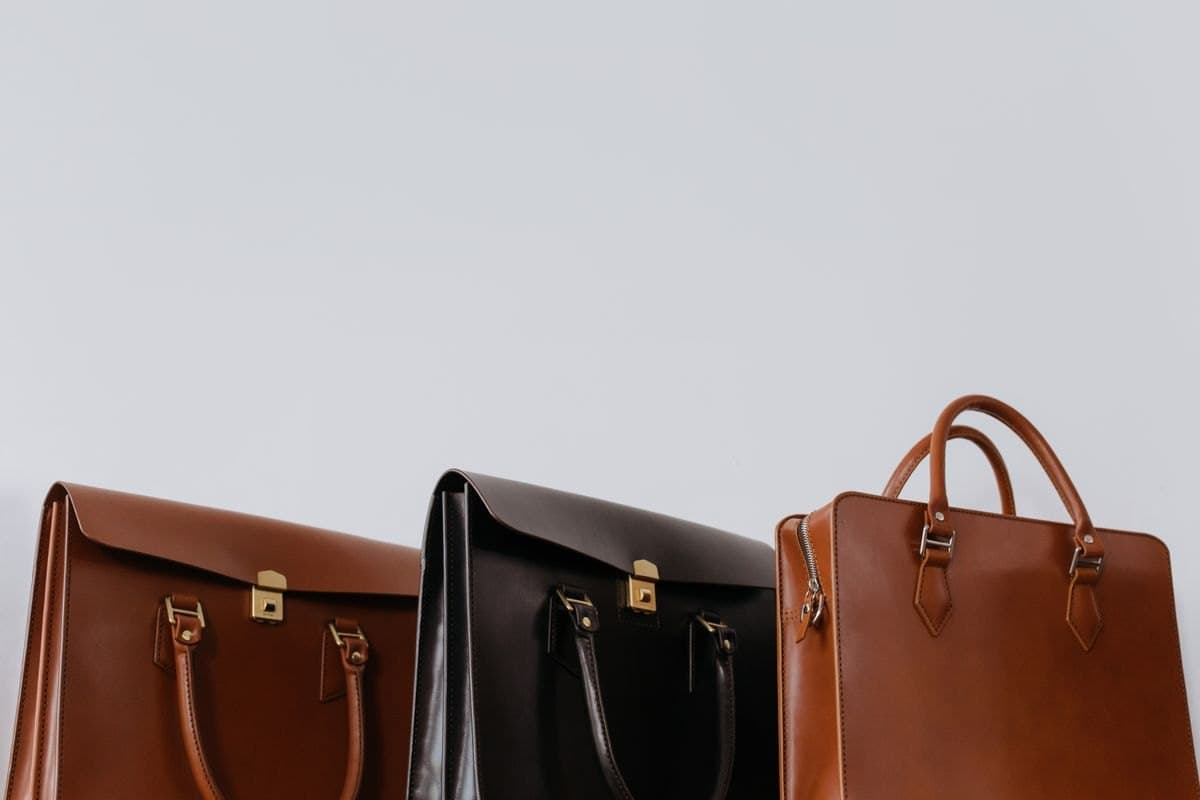 Three structured leather tote bags in tan and black