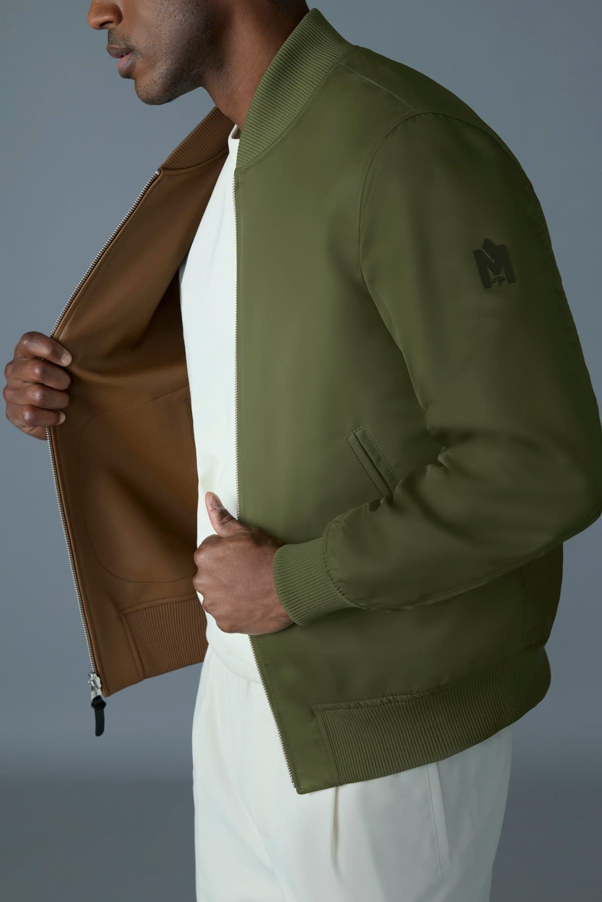 Model in an olive leather bomber jacket