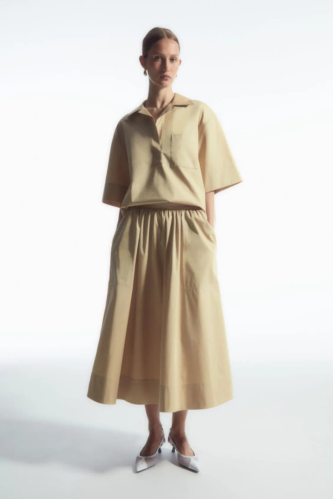 Model in a sand poplin A-line midi skirt
