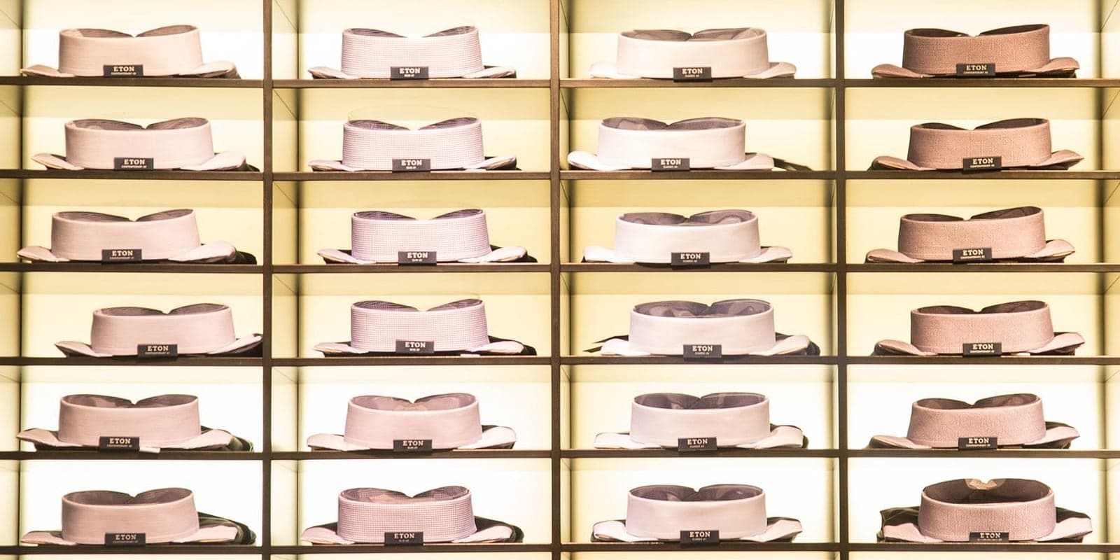 A boutique wall of neatly stacked dress shirts