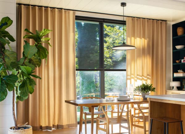 Palomino striped cubicle-heading drapes by a dining table