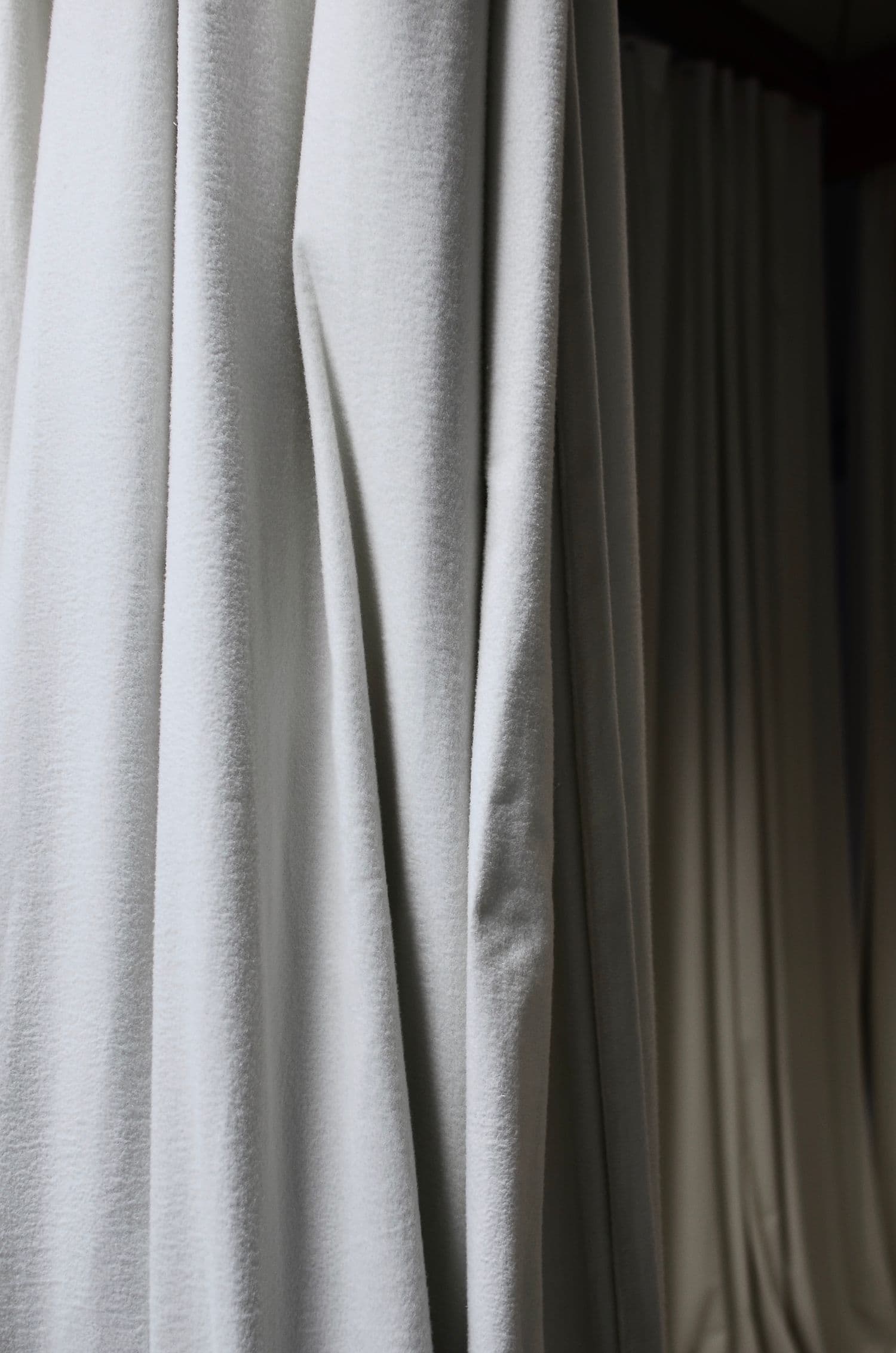 Soft folds of pale grey-white drapery