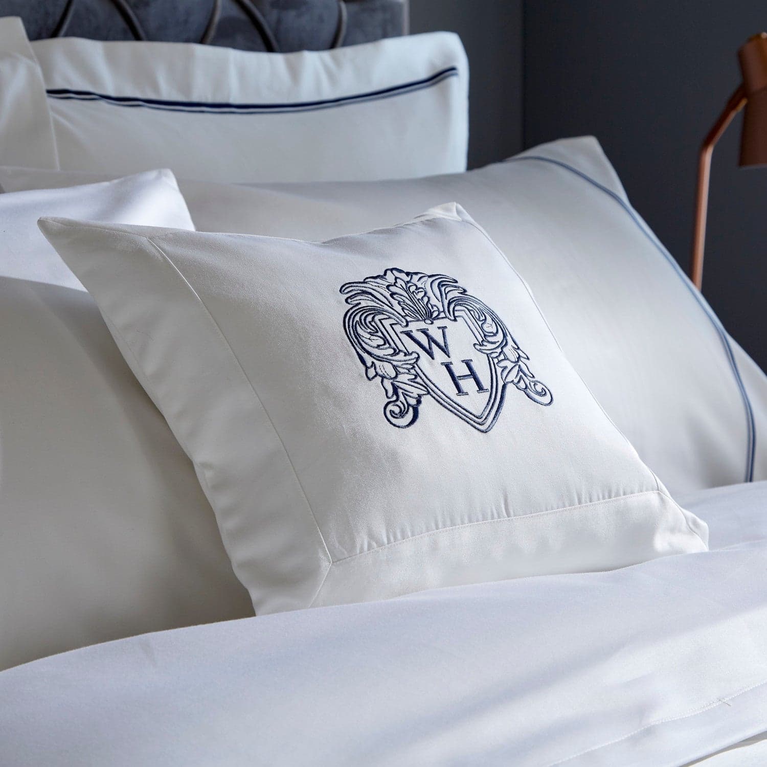 White boudoir cushion cover with navy embroidery