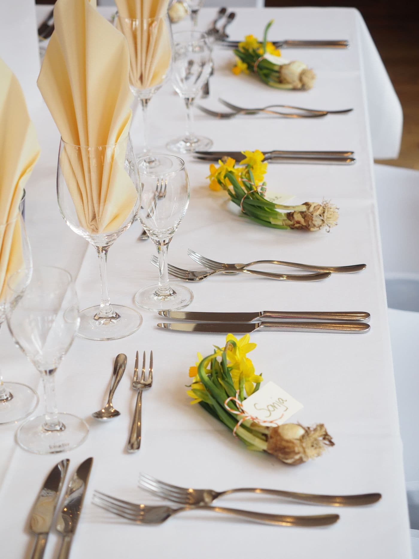 A bright white place setting with silver cutlery
