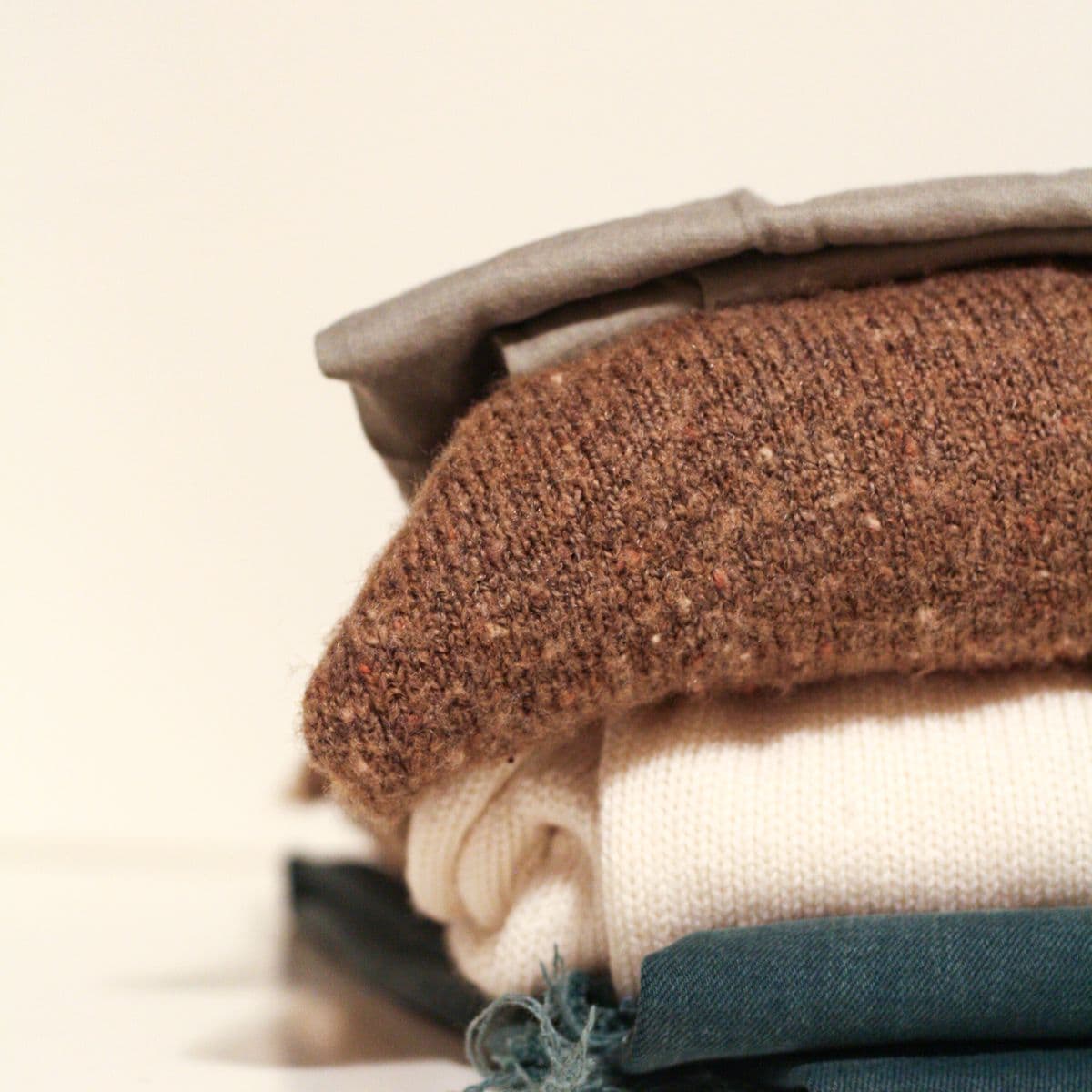 A folded stack of neutral knit activewear