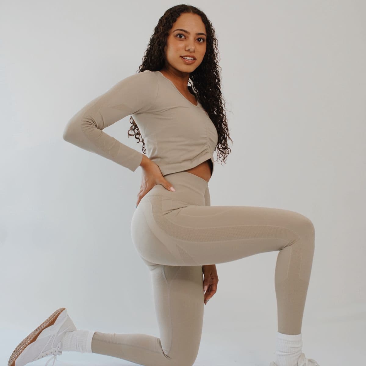 Model in a stone long-sleeve top and matching leggings