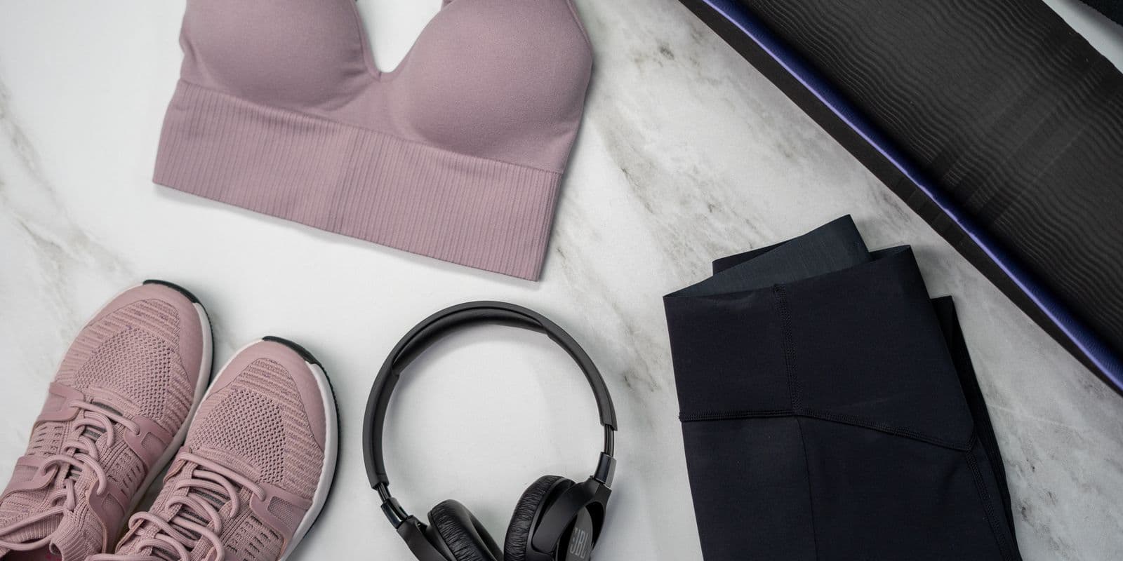 A flat-lay of a sports bra and folded leggings