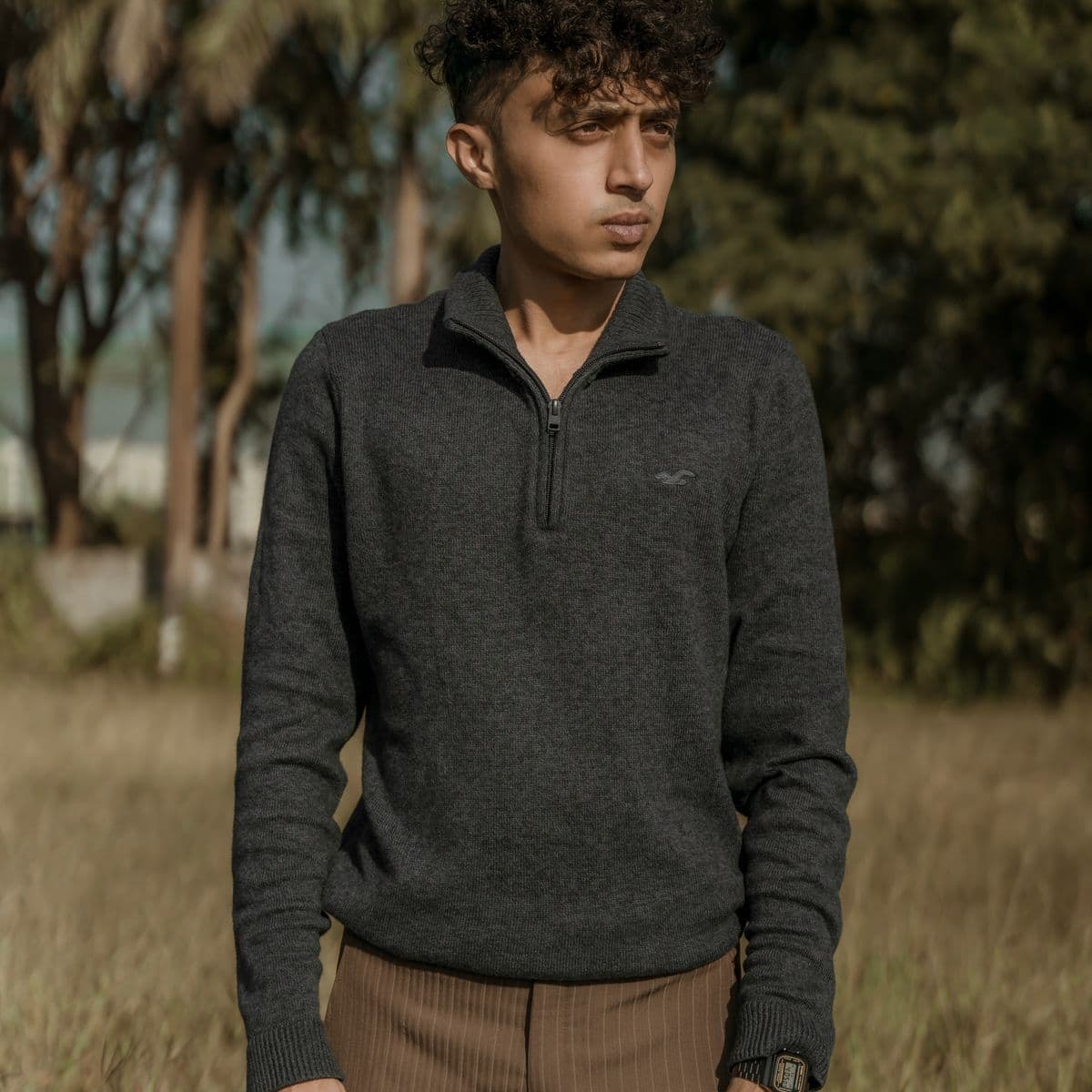 Man in a charcoal quarter-zip knit pullover