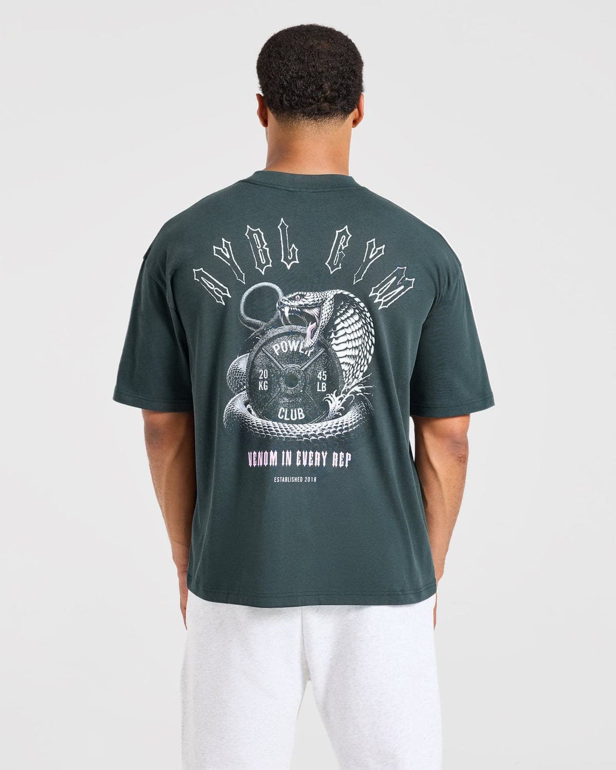 Dark teal oversized performance tee on model